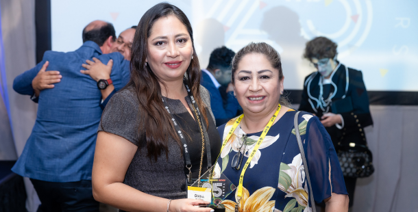 Diana Villagas and Jenny Villaga, leaders of Nova Driving School, accepting the 2023 IC100 Award at the Annual Conference in Miami. 