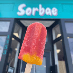 Photo of a Sorbae popsicle held in front of the storefront.